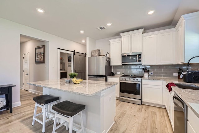116 Angel Oak Way, San Marcos, TX 78666 - kitchen with white cabinetry, a sink, backsplash, and appliances with stainless steel finishes