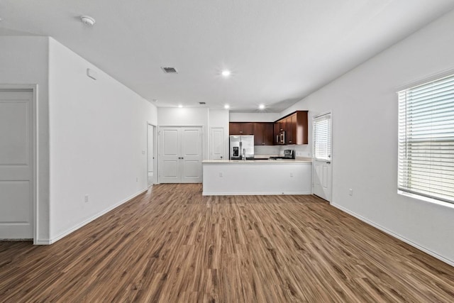 3313 Lodgepole Dr, Austin, TX 78744 - unfurnished living room featuring wood finished floors, baseboards, visible vents, and recessed lighting
