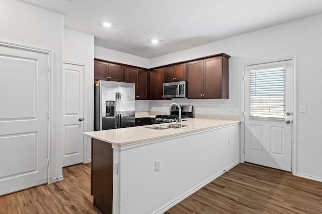3313 Lodgepole Dr, Austin, TX 78744 - kitchen featuring light countertops, appliances with stainless steel finishes, a sink, and dark wood finished floors