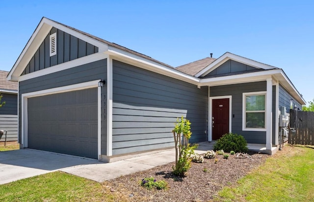 3313 Lodgepole Dr, Austin, TX 78744 - view of front of house featuring board and batten siding, an attached garage, fence, and driveway