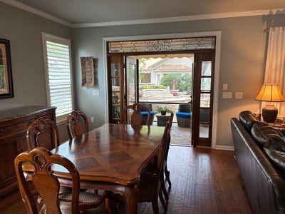 122 Camp Dr, Georgetown, TX 78633 - dining area with dark wood-style floors, crown molding, and baseboards
