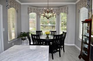 122 Camp Dr, Georgetown, TX 78633 - dining area featuring a chandelier, baseboards, and crown molding