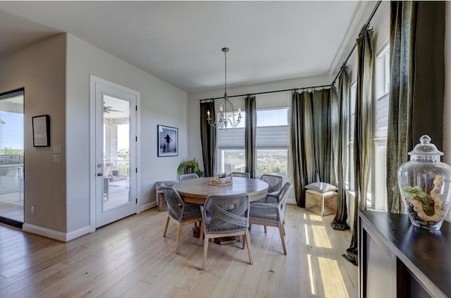 304 Ashburn Cv, Austin, TX 78738 - dining room with a chandelier, light wood-style flooring, and baseboards