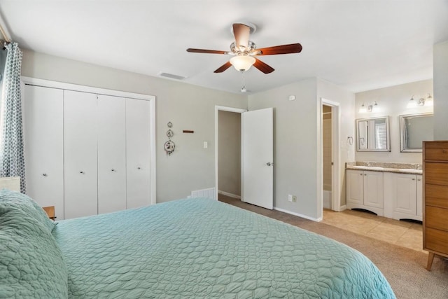 1405 Meadowmear Dr, Austin, TX 78753 - bedroom featuring light carpet, a closet, baseboards, a ceiling fan, and ensuite bathroom