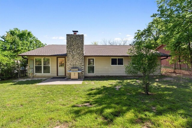 1405 Meadowmear Dr, Austin, TX 78753 - back of house with a patio, a lawn, a chimney, and roof with shingles