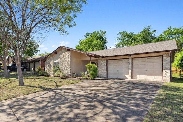 1405 Meadowmear Dr, Austin, TX 78753 - view of front of house with stone siding, a garage, concrete driveway, and a front lawn