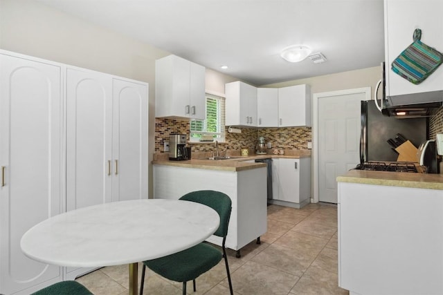 1405 Meadowmear Dr, Austin, TX 78753 - kitchen featuring decorative backsplash, white cabinets, a sink, and light tile patterned flooring