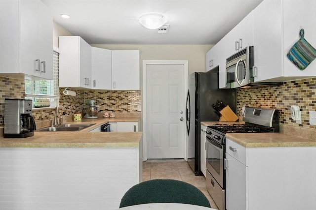 1405 Meadowmear Dr, Austin, TX 78753 - kitchen with appliances with stainless steel finishes, a sink, light countertops, tasteful backsplash, and white cabinetry
