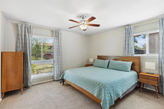 1405 Meadowmear Dr, Austin, TX 78753 - bedroom with multiple windows, light carpet, a ceiling fan, and baseboards