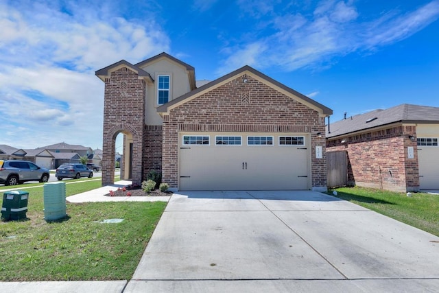 201 Canley Loop, Hutto, TX 78634 - view of front of house featuring brick siding, a garage, a front lawn, and concrete driveway
