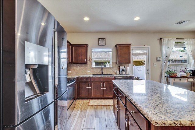 1012 Lost Pines Ln, Cedar Park, TX 78613 - kitchen with stainless steel fridge, a sink, backsplash, light stone countertops, and recessed lighting