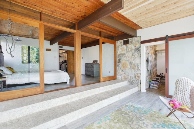 7106 Mountain Trl, Austin, TX 78732 - bedroom with a wood ceiling with exposed beams, a barn door, and wood finished floors