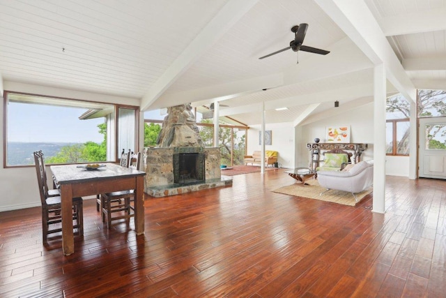 7106 Mountain Trl, Austin, TX 78732 - living area with a stone fireplace, wood finished floors, a ceiling fan, and plenty of natural light
