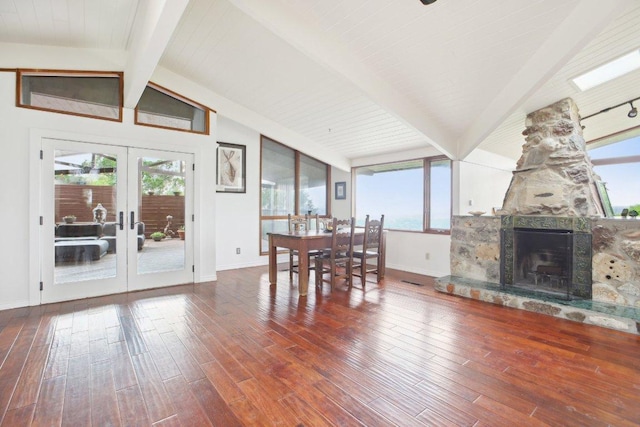 7106 Mountain Trl, Austin, TX 78732 - dining space with hardwood / wood-style floors, healthy amount of natural light, and a stone fireplace