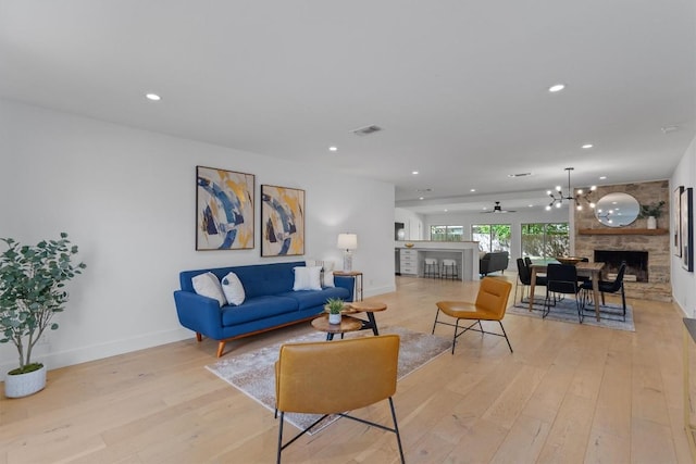 3306 Whiteway Dr, Austin, TX 78757 - living room featuring light wood finished floors, baseboards, recessed lighting, visible vents, and a stone fireplace