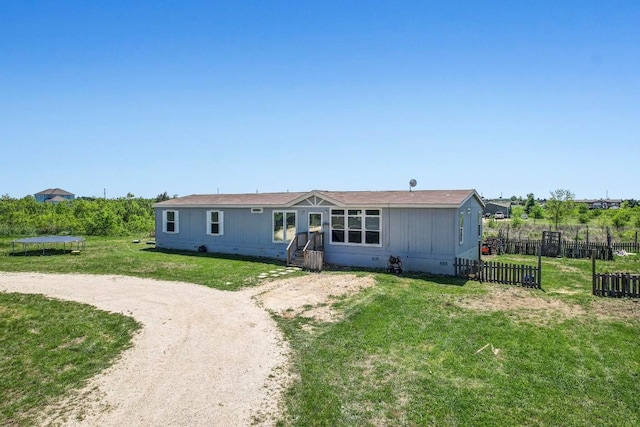 108 Gran Cielo, Elgin, TX 78621 - manufactured / mobile home featuring a trampoline, crawl space, and dirt driveway