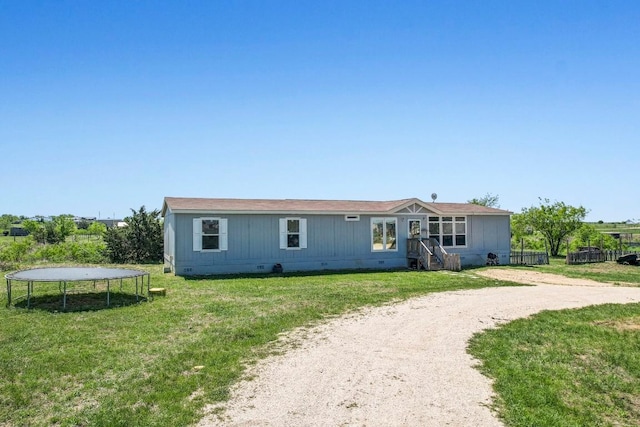 108 Gran Cielo, Elgin, TX 78621 - manufactured / mobile home featuring a trampoline, crawl space, and a front lawn