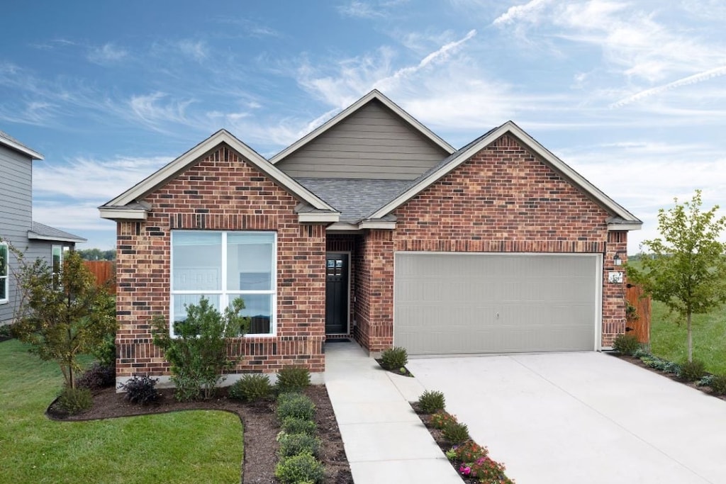 303 Pitkin Dr, Lockhart, TX 78644 - ranch-style house featuring concrete driveway, roof with shingles, a front lawn, brick siding, and a garage