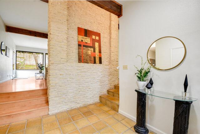 6304 Whitemarsh Valley Walk, Austin, TX 78746 - hallway featuring baseboards, tile patterned flooring, stairs, and beam ceiling