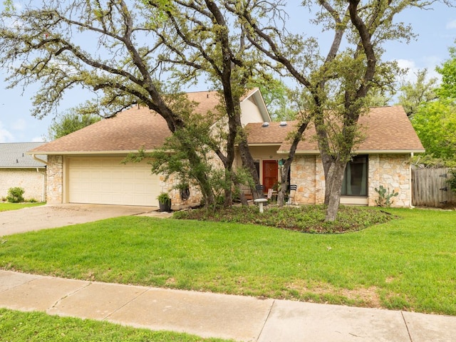 view of front of property featuring stone siding, a front lawn, an attached garage, a shingled roof, and concrete driveway