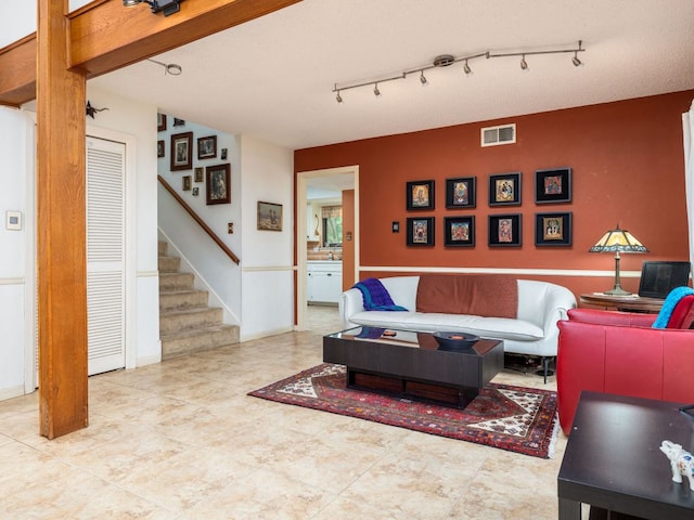 living room with visible vents and stairway