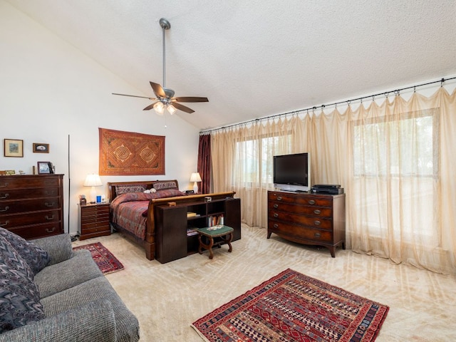 bedroom with a textured ceiling, ceiling fan, lofted ceiling, and carpet floors