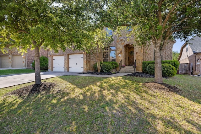 1812 Buffalo Thunder, Leander, TX 78641 - view of property hidden behind natural elements featuring driveway, stone siding, a front lawn, and a garage