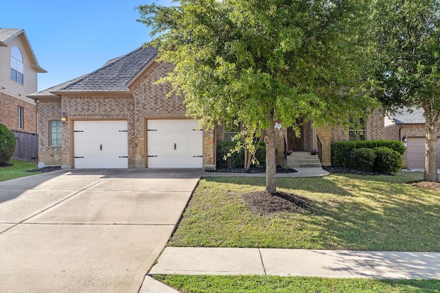 1812 Buffalo Thunder, Leander, TX 78641 - view of property hidden behind natural elements featuring concrete driveway, a garage, brick siding, roof with shingles, and a front yard