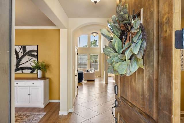 1812 Buffalo Thunder, Leander, TX 78641 - foyer entrance featuring baseboards, arched walkways, tile patterned floors, and crown molding