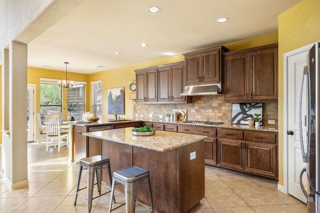 1812 Buffalo Thunder, Leander, TX 78641 - kitchen with a peninsula, light tile patterned floors, stainless steel appliances, decorative backsplash, and recessed lighting