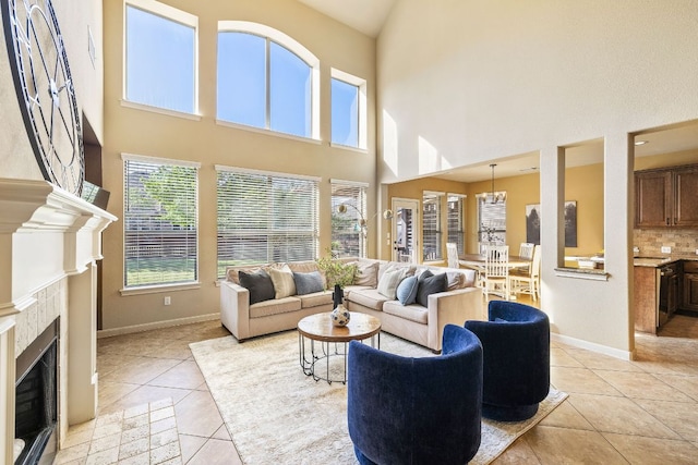 1812 Buffalo Thunder, Leander, TX 78641 - living room featuring light tile patterned floors, a high ceiling, baseboards, and a fireplace