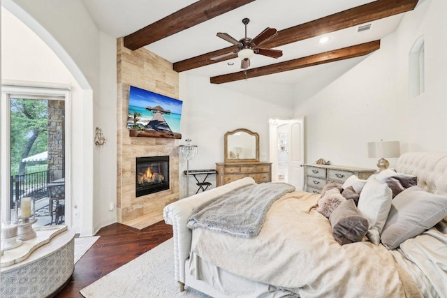 bedroom with a tile fireplace, beamed ceiling, access to outside, baseboards, and dark wood-type flooring