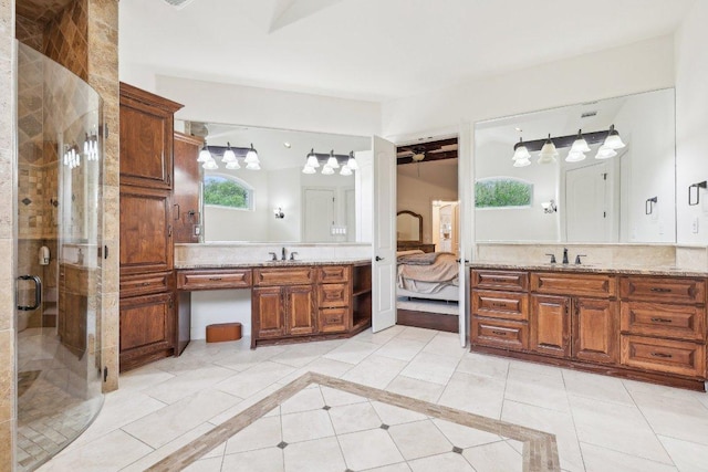 ensuite bathroom featuring a stall shower, two vanities, a sink, and connected bathroom
