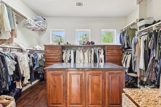 spacious closet with visible vents and dark wood-type flooring