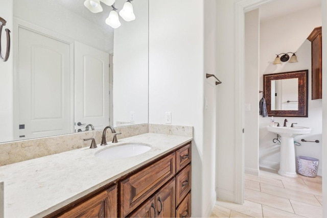 bathroom featuring tile patterned floors, baseboards, and a sink