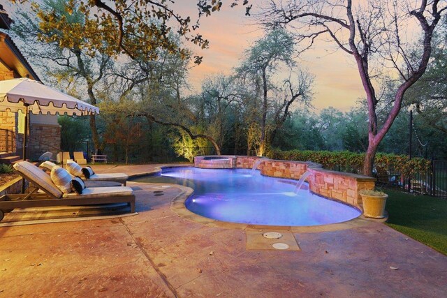 view of pool featuring fence, a fenced in pool, an in ground hot tub, and a patio area
