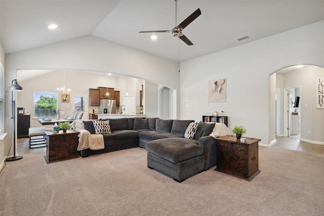 319 Silver Glen Dr, Kyle, TX 78640 - living room featuring arched walkways, light carpet, ceiling fan, lofted ceiling, and a chandelier