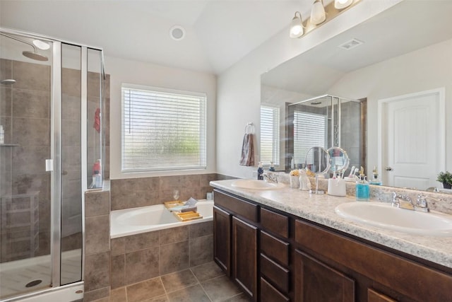 319 Silver Glen Dr, Kyle, TX 78640 - bathroom featuring double vanity, a shower stall, a bath, lofted ceiling, and tile patterned floors