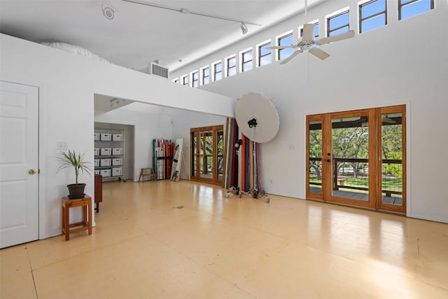 1005 Lisa Dr, Austin, TX 78733 - unfurnished room with healthy amount of natural light, a ceiling fan, a high ceiling, rail lighting, and tile patterned floors