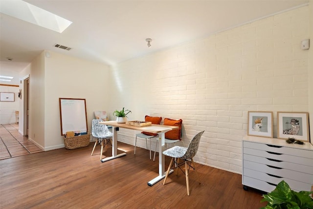 1005 Lisa Dr, Austin, TX 78733 - office area featuring brick wall, a skylight, and wood finished floors
