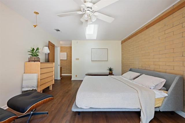 1005 Lisa Dr, Austin, TX 78733 - bedroom featuring brick wall, a skylight, wood finished floors, and a ceiling fan