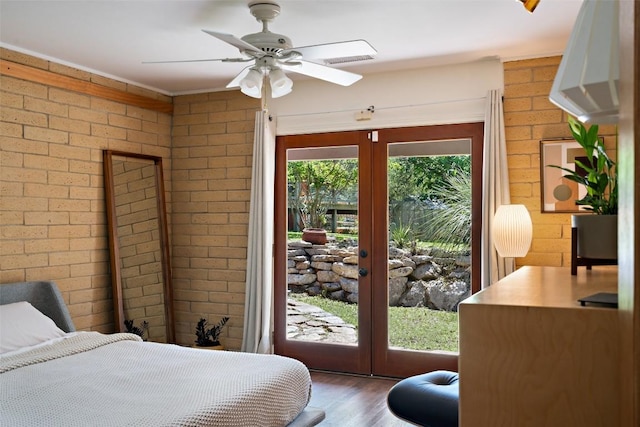 1005 Lisa Dr, Austin, TX 78733 - bedroom with french doors, wood finished floors, access to outside, brick wall, and ceiling fan