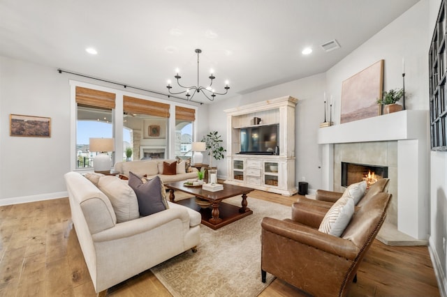 16319 Golden Top Dr, Austin, TX 78738 - living area featuring a tile fireplace, a chandelier, light wood finished floors, and recessed lighting