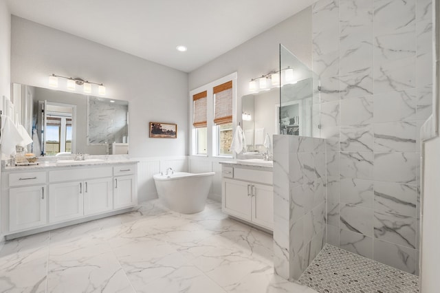 16319 Golden Top Dr, Austin, TX 78738 - full bath with healthy amount of natural light, a marble finish shower, a freestanding tub, wainscoting, and two vanities