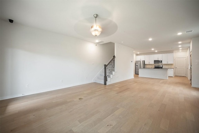 2500 Forest Creek Dr Unit 2501, Round Rock, TX 78665 - unfurnished living room featuring recessed lighting, stairs, a ceiling fan, light wood-style flooring, and baseboards