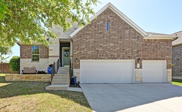 650 Ledge Stone Dr, Austin, TX 78737 - view of front of property featuring driveway, stone siding, a front lawn, and brick siding