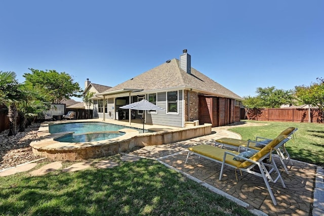 650 Ledge Stone Dr, Austin, TX 78737 - back of house with a patio, brick siding, roof with shingles, a chimney, and a pool with connected hot tub