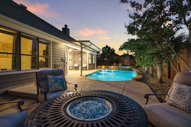 650 Ledge Stone Dr, Austin, TX 78737 - pool at dusk featuring a patio, a fenced backyard, and a fire pit