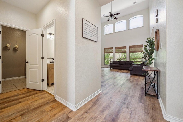 12907 Gordons Hvn, San Antonio, TX 78253 - hallway with light wood-style flooring, a towering ceiling, and a textured wall