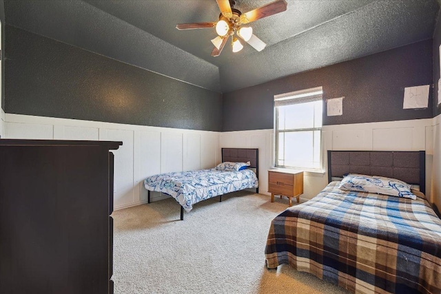 12907 Gordons Hvn, San Antonio, TX 78253 - carpeted bedroom with a decorative wall, wainscoting, a textured ceiling, ceiling fan, and vaulted ceiling